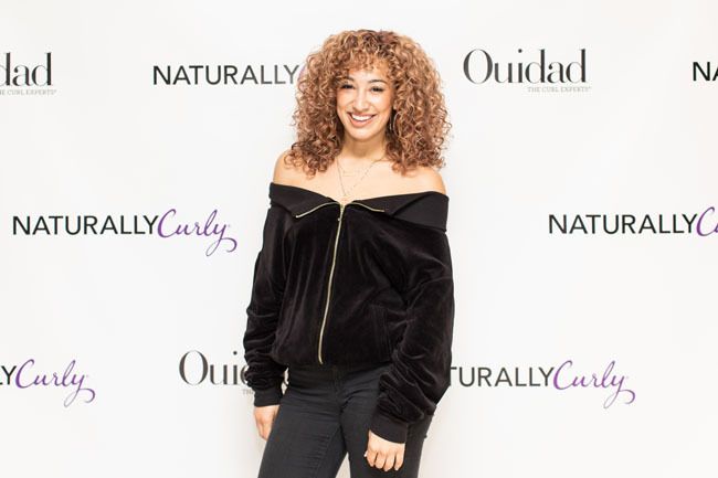 curly attendee at the book tour