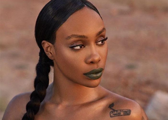 Singer Sza wearing green lipstick from Fenty Beauty