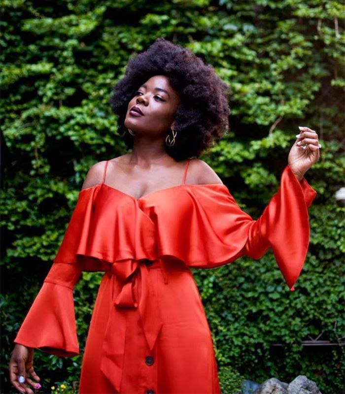 African-American woman with an afro wearing a red dress