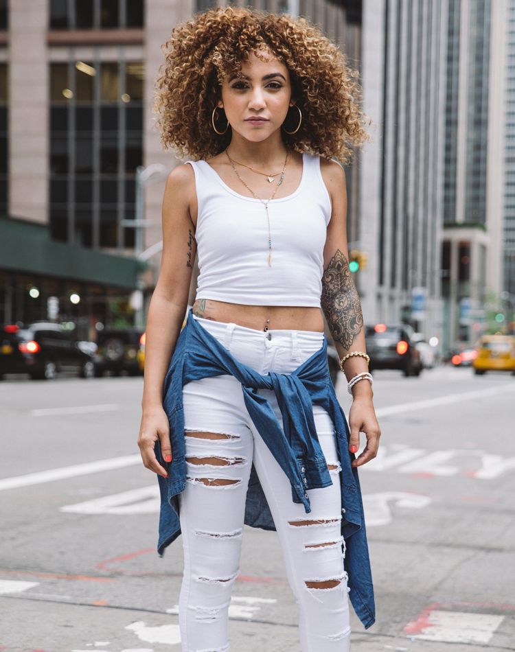 Tiffany Tattooz stands in the street staring down the camera