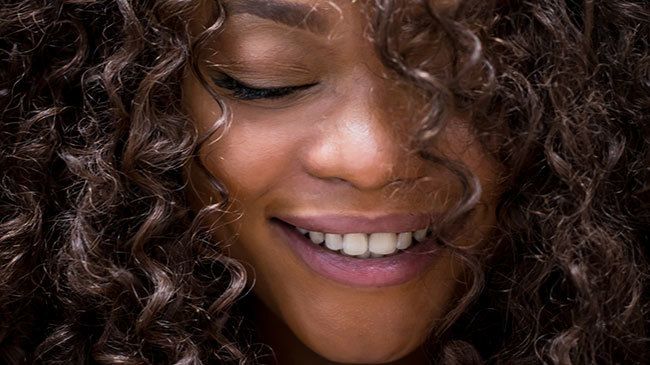 woman with curly hair by andresr for istock