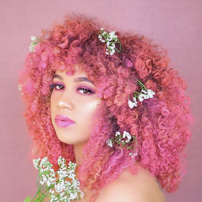 Woman with pink curly hair