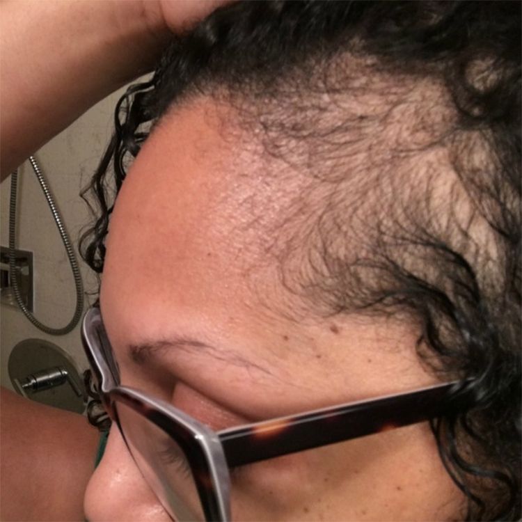 Afro-latina woman wearing glasses and showing her bald edges