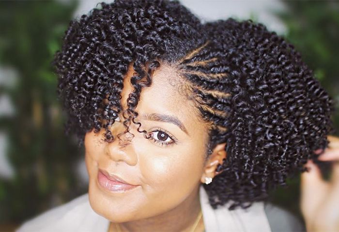 African-American woman with curly hair smiling