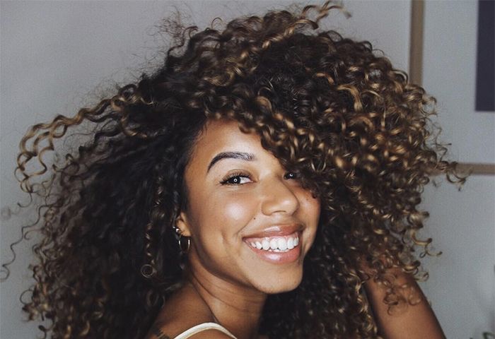 Women smiling with curly hair