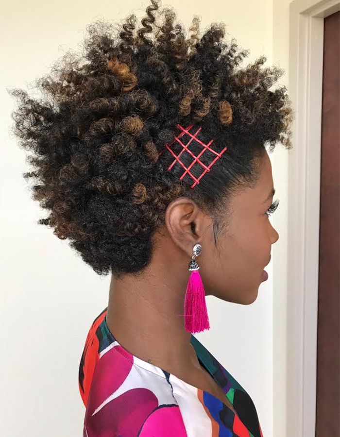 African-American woman with curly hair and pink bobby pins