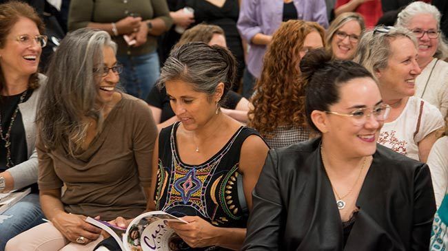 Attendees of The Curl Revolution book signing enjoy listening to Michelle Breyer during Q & A session.