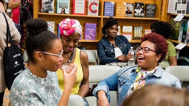 Young women with curly hair styles enjoy themselves at BookPeople.