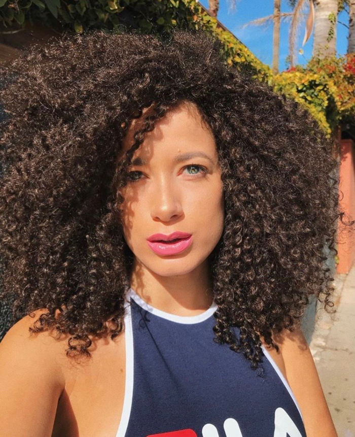 woman outside wearing tank top and big crochet braids crochet braids